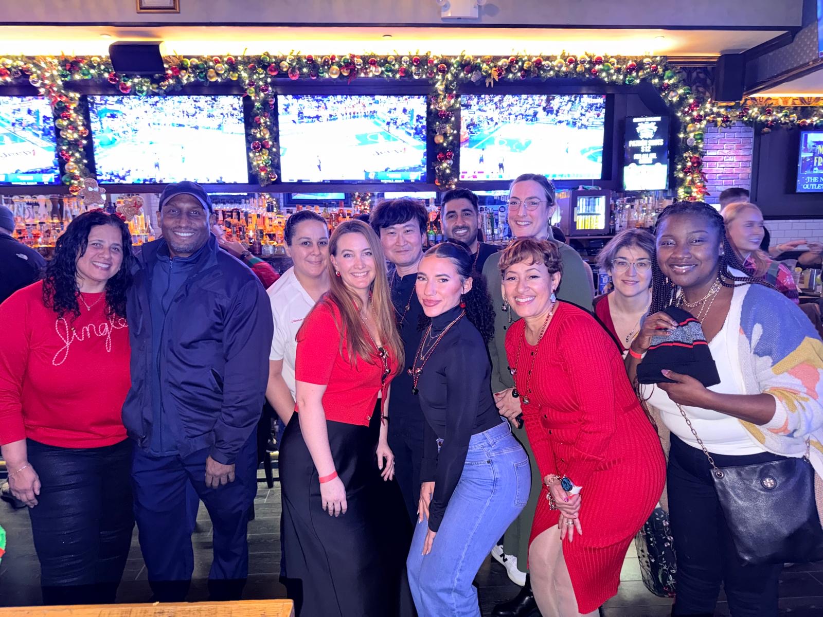 Group of nurses smiling together at a holiday gathering.